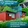 A security camera is shown monitoring a red shed in a garden setting. Produktbild-Vorschau