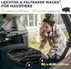 A woman is placing a folded black wagon into the trunk of a car. Produktbild-Vorschau