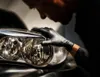 A person wearing black gloves is inspecting a car headlight. Náhľad obrázku produktu