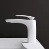 A white faucet is shown against a black background, with the base of the faucet resting on a white sink. Produktbild-Vorschau