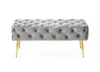 A tufted upholstered bench with gold legs on a white background. Produktbild-Vorschau