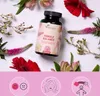 A bottle of Vegavero Female Balance Complex surrounded by flowers, with three circular icons below depicting mood, skin, and well-being. Produktbild-Vorschau