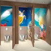 Three bathroom stalls with underwater themed murals and modern fixtures. Anteprima dell’immagine prodotto