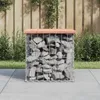 A gabion bench with a wooden top sits on a paved patio, with a wooden fence and greenery in the background. Náhľad obrázku produktu