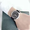 A person's wrist wearing a Citizen watch, resting on a dark green textured surface. Náhľad obrázku produktu