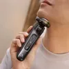 A person is shaving their face with a Philips electric razor. Náhled obrázku produktu
