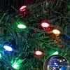 Close-up of colorful LED string lights on a Christmas tree in the rain. Voir les images du produit