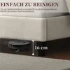 A robot vacuum cleaner is shown cleaning under a bed frame, illustrating the bed's clearance. Podgląd zdjęcia produktu