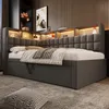 A modern bedroom with a grey upholstered daybed featuring built-in shelving and lighting. Náhled obrázku produktu