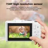 A hand holding a white digital camera, displaying a picture of a child with a toy rabbit on its screen, with a blurred green background. Voir les images du produit