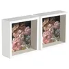 Two white deep box picture frames, each containing a floral arrangement of pink and white flowers. Produktbild-Vorschau