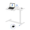 A white adjustable height desk with a laptop, a plant, and a cup of coffee on it, shown against a white background. Voir les images du produit