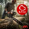 A man is using a chainsaw to cut a log in a forest. Produktbild-Vorschau