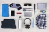 A flat lay of various travel and personal items arranged on a light wooden surface. Náhľad obrázku produktu