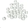A collection of clear glass marbles arranged on a white background. Podgląd zdjęcia produktu