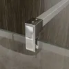 Close-up of a shower wall fixture and glass panel. Produktbild-Vorschau
