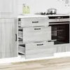 A kitchen cabinet with drawers partially open, next to an oven. Náhľad obrázku produktu