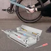 A person is working on a bicycle with a toolbox nearby. Podgląd zdjęcia produktu