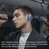 A man wearing earbuds on public transport. Náhled obrázku produktu