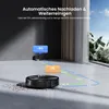 A robot vacuum cleaner is shown on a floor with debris, with arrows indicating its cleaning path and charging station. Produktbild-Vorschau