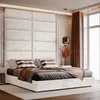 A bedroom scene featuring a large upholstered headboard and bed. Anteprima dell’immagine prodotto