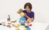 A child is playing with modeling clay, creating space-themed objects. Produktbild-Vorschau