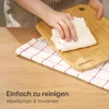 A person is wiping a wooden cutting board with a white cloth, with a red and white checkered towel underneath. Anteprima dell’immagine prodotto