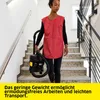 A woman is carrying a vacuum cleaner down a set of stairs. Voir les images du produit