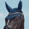 Close-up of a horse's head wearing a navy blue fly bonnet with gold crystal embellishments. Voir les images du produit