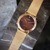 A close-up shot of a gold Citizen Eco-Drive watch with a brown dial, placed on a dark marble surface. Produktbild-Vorschau