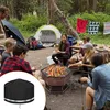 A group of people are camping and having a barbecue around a fire pit. Produktbild-Vorschau