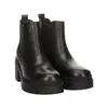 A pair of black Chelsea boots with a chunky heel and sole, shown from the front on a white background. Produktbild-Vorschau