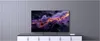 A television displaying a colorful abstract image, placed on a cabinet against a paneled wall. Produktbild-Vorschau