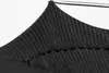 A close-up of black fabric with a ribbed texture, possibly part of a garment or accessory, hanging from a metal rod. Produktbild-Vorschau