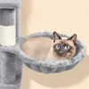A Siamese cat is relaxing in a hammock on a cat tree. Produktbild-Vorschau