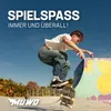 A skateboarder performing a trick in a skatepark. Produktbild-Vorschau