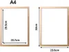 Two picture frames are shown side-by-side with dimensions indicated. The left frame is labeled 'A4' and has dimensions 29.5cm and 20.7cm. The right frame has dimensions 32cm and 23.6cm. Anteprima dell’immagine prodotto