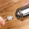 A close-up shot of a person's hands holding a metal attachment to a larger metal object, suggesting assembly or connection. Voir les images du produit