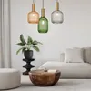 A modern living room with a sofa, coffee table, plant, and pendant lights. Anteprima dell’immagine prodotto