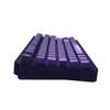 A side view of a dark-colored mechanical keyboard with purple, illuminated keycaps. Produktbild-Vorschau