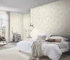 A bedroom scene with a bed, rocking chair, and decorative items. Podgląd zdjęcia produktu