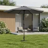 A gray patio umbrella is set up on a green lawn in front of a modern house with outdoor seating. Voir les images du produit