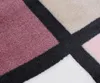 A close-up view of a textured blanket with a geometric pattern. Produktbild-Vorschau