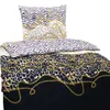 A bedding set with a pillow and a duvet cover, featuring animal prints and gold chain patterns. Produktbild-Vorschau