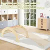 A wooden climbing arch and slide set for children in a playroom, with a large window and a chest of drawers in the background. Podgląd zdjęcia produktu