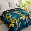 A blanket with a butterfly pattern is laid out on a bed. Produktbild-Vorschau