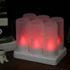 A set of six LED tea lights on a charging base, with a small hedgehog figurine in the foreground. Produktbild-Vorschau