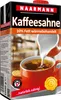 A carton of coffee cream being poured into a cup of coffee. Anteprima dell’immagine prodotto