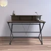 A desk with a shelf and decorative items on it, set against a plain wall. Produktbild-Vorschau