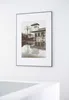 A framed picture of a building with a reflection in water. Anteprima dell’immagine prodotto